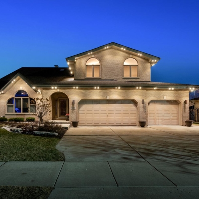 Architectural lighting highlights your home with our permanent track lighting along the roofline, th Photo