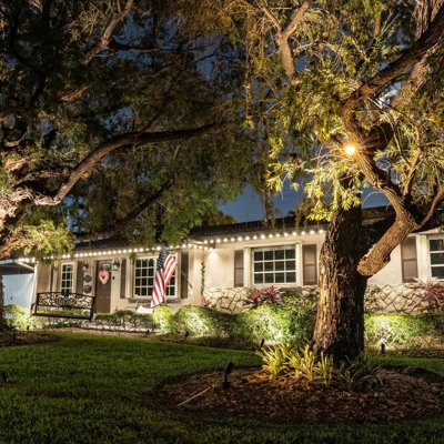 Permanent roofline lighting and landscape lighting transformed this home in Miami, FL   Photo