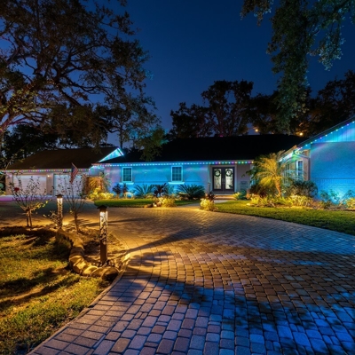 Orange County home with blue permanent roofline lighting Photo