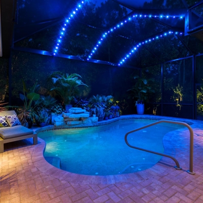 Blue lanai lighting in this Lakewood Ranch home sets the mood for a relaxing evening. Photo