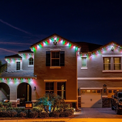two-story Orange County home with red, green and white permanent roofline lighting Photo