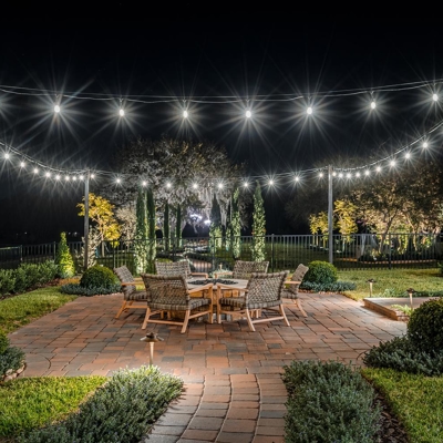 Add bistro lighting to any outdoor space to use after dark in Sarasota, FL. Photo