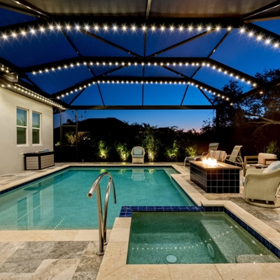 Permanent holiday lighting adds ambiance to this home in Pinecrest, FL with a warm white color that  Photo