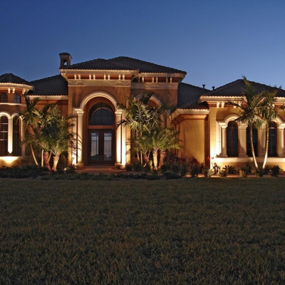 Curb appeal lighting on this Palmetto Bay home add beauty after dark.  Photo