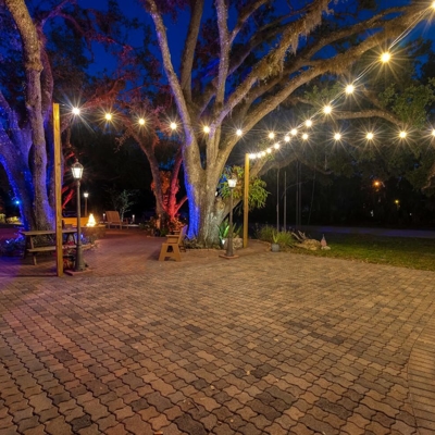 Bistro lighting can add warm white lighting to any patio or outdoor space in Coral Gables, FL.   Photo