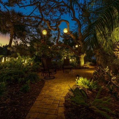 The landscape and sphere lighting creates a unique ambiance in this backyard in Miami, FL. Photo
