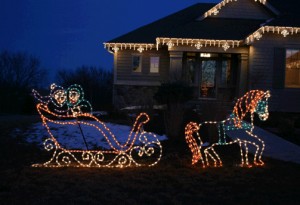 Holiday lighting installation of a light-up sled with horse