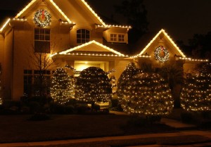 Christmas light installation of a two story house and landscape lighting