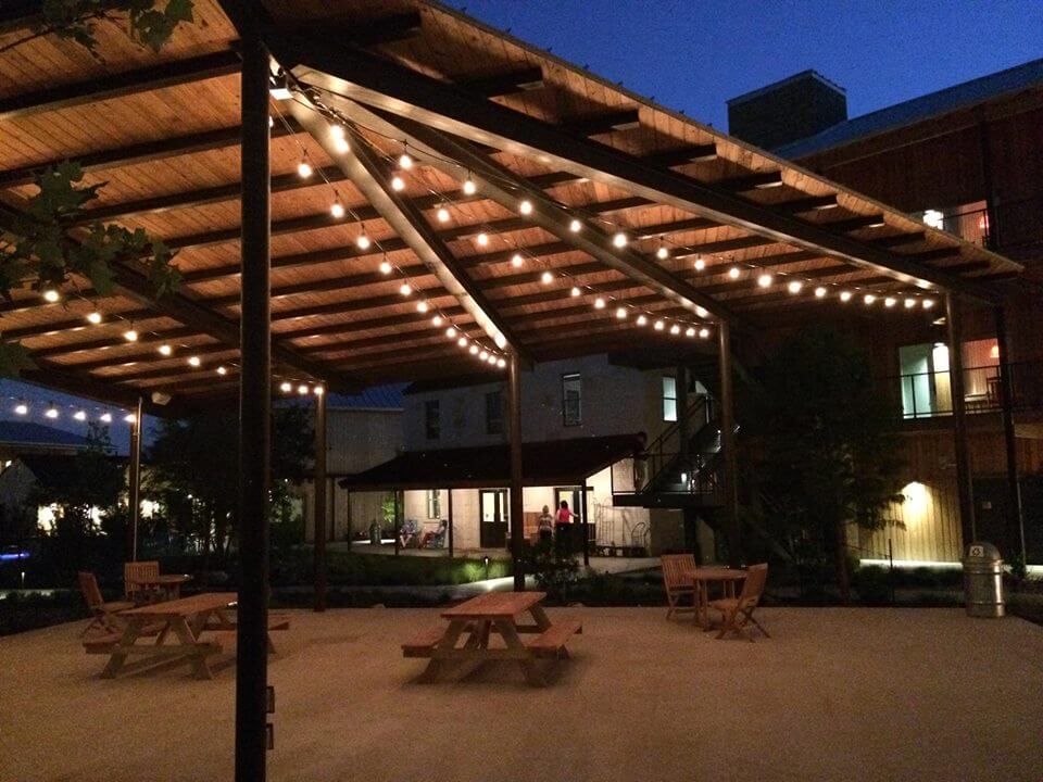 Hamilton Square hotel with string lighting on patio