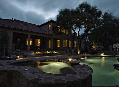 Backyard with outdoor pool lighting