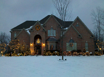 Home with tree wrapping holiday lighting