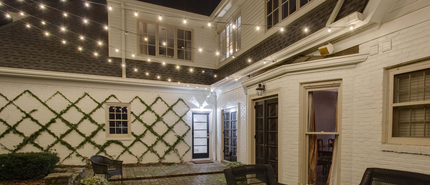 Patio lighting on white house