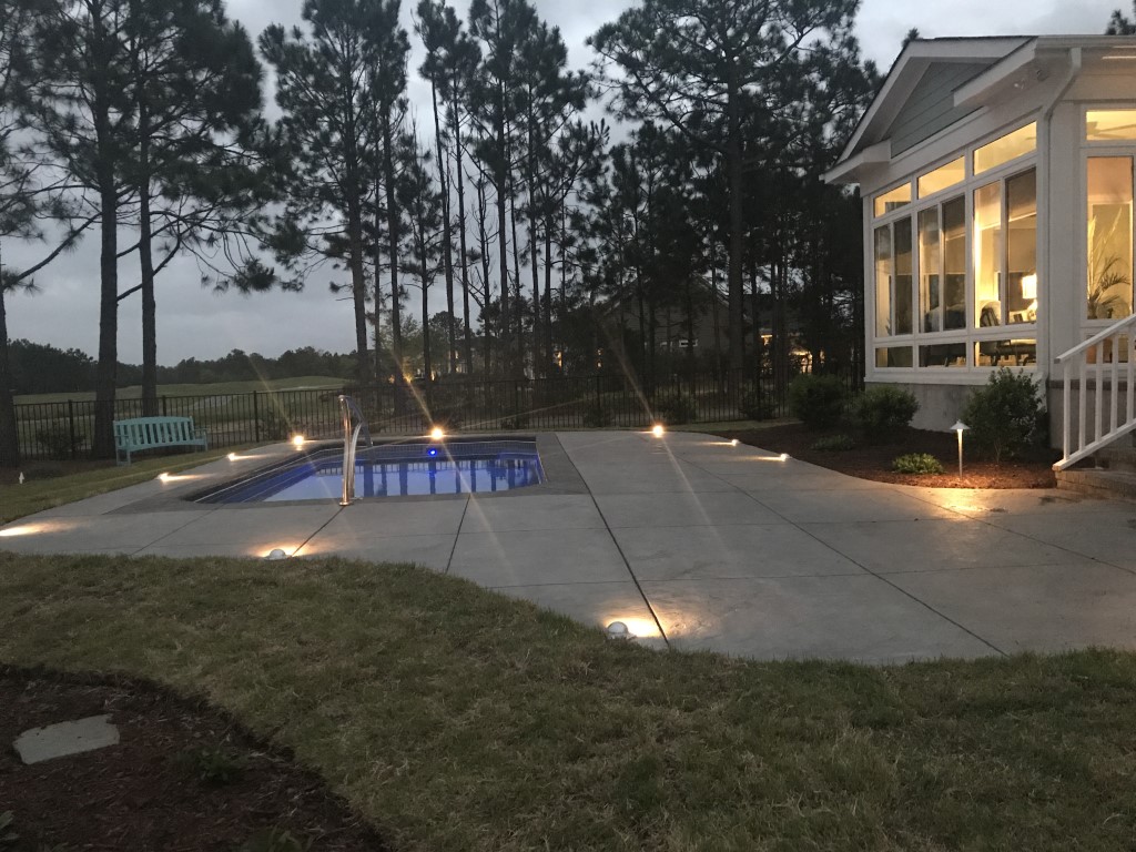 backyard with pool at twilight with path lighting