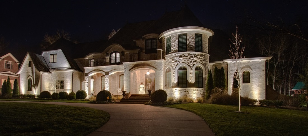 large white house with outdoor lighting