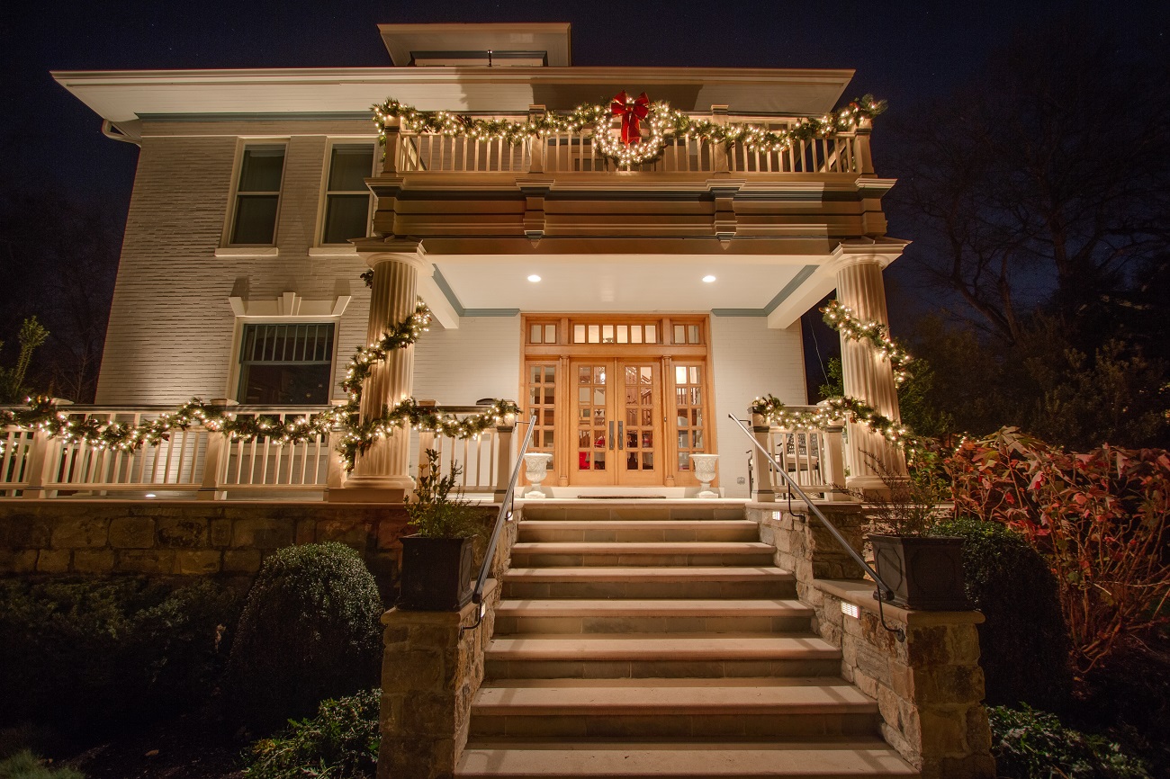 Front door entry way decorated with Christmas lights and decor