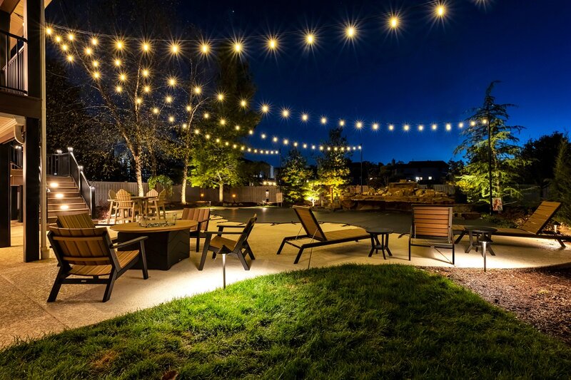 Outdoor patio with string overhead lighting and patio furniture
