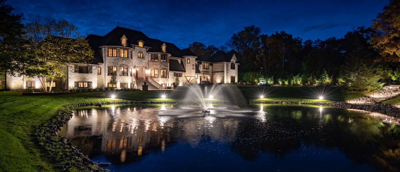 A house with a fountain in front of itDescription automatically generated with low confidence
