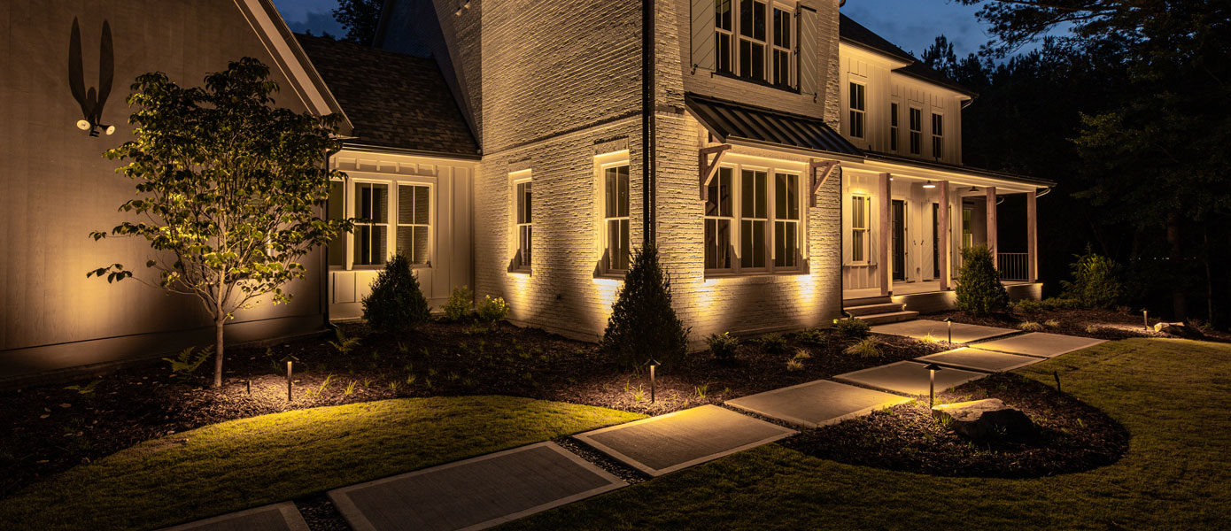 A house with lights on the side

Description automatically generated