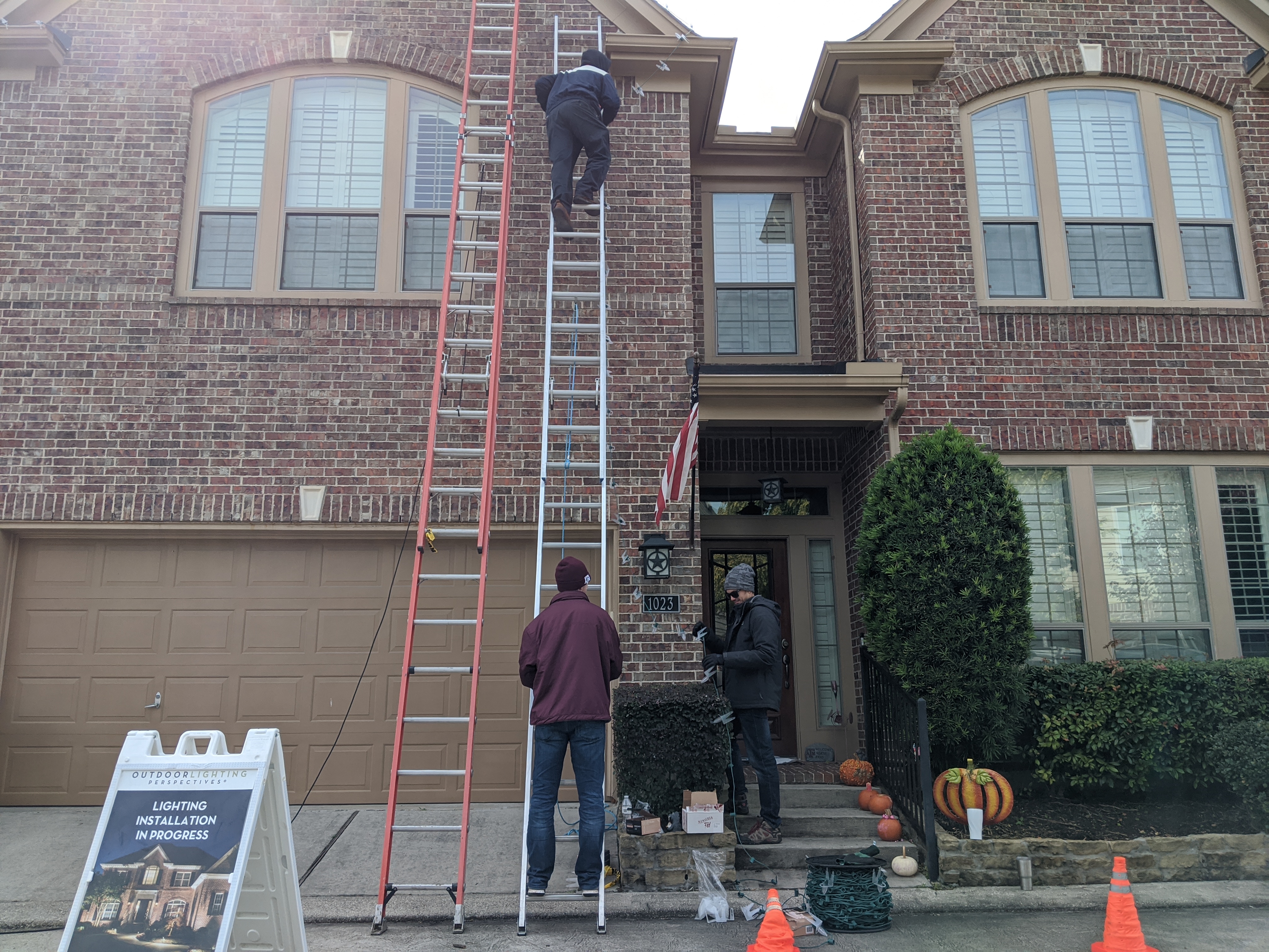 brick facade with men on a ladder