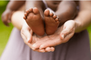 Baby's feet on mom's hands