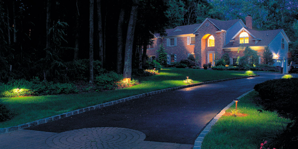Front of large home and driveway with special lighting