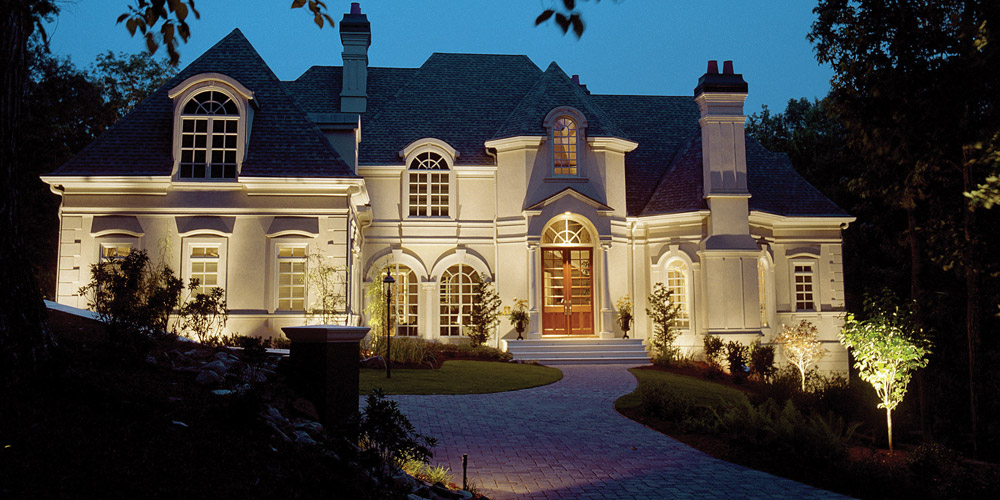 Front of a large home with specialty lighting