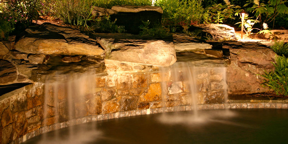 Water feature with landscape lighting