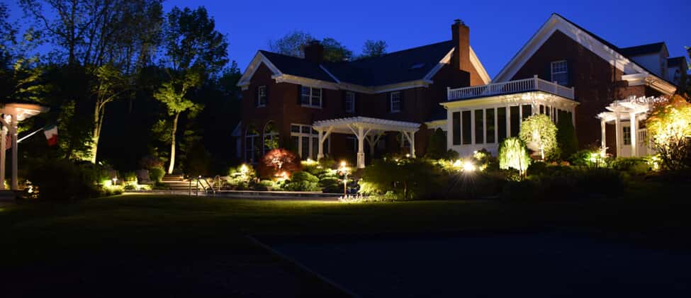 residential front yard with illumination lighting on planters 