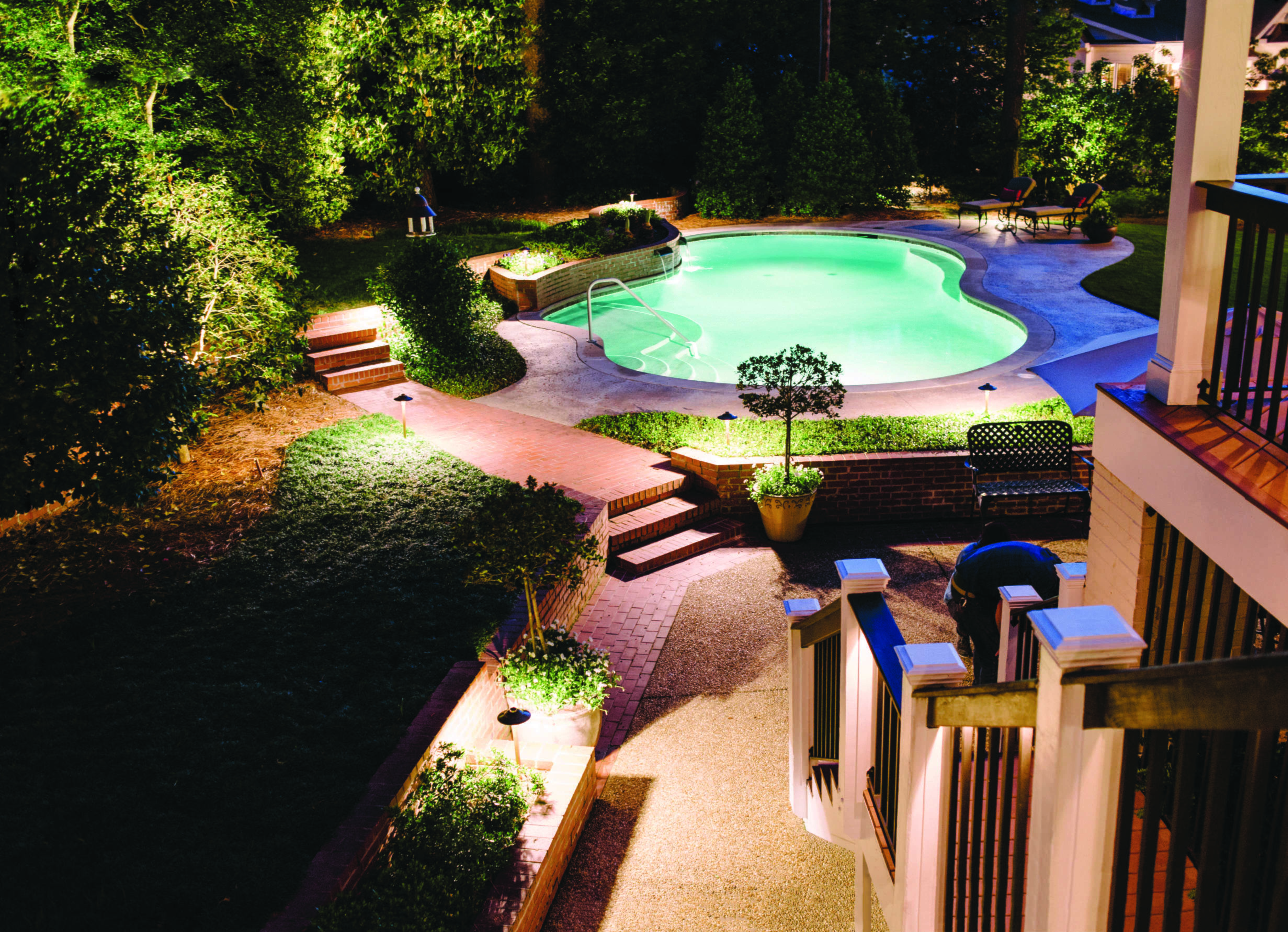 A pool in a backyard at nightDescription automatically generated