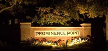 Prominence Point sign illuminated by lights