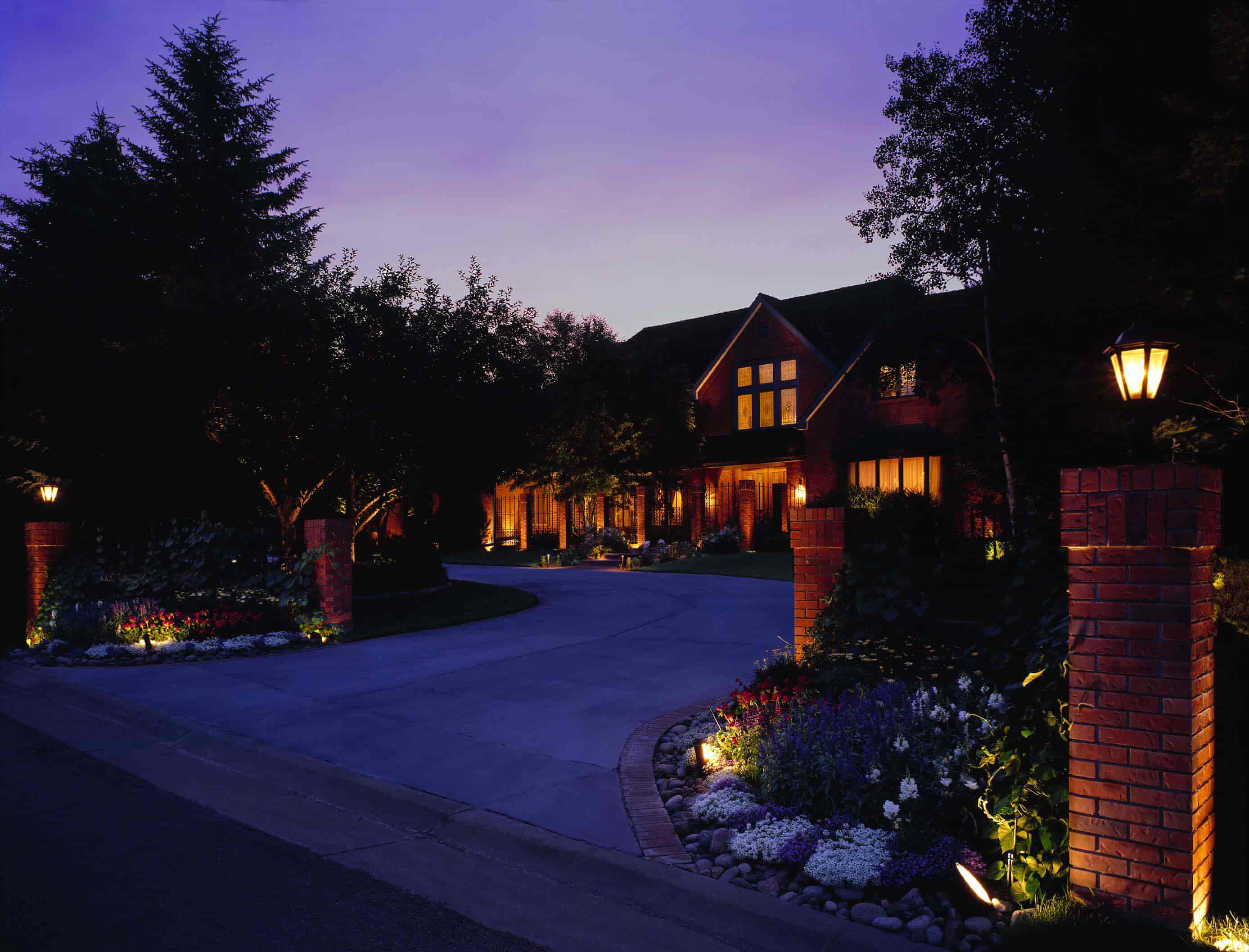 driveway lit by outdoor lighting