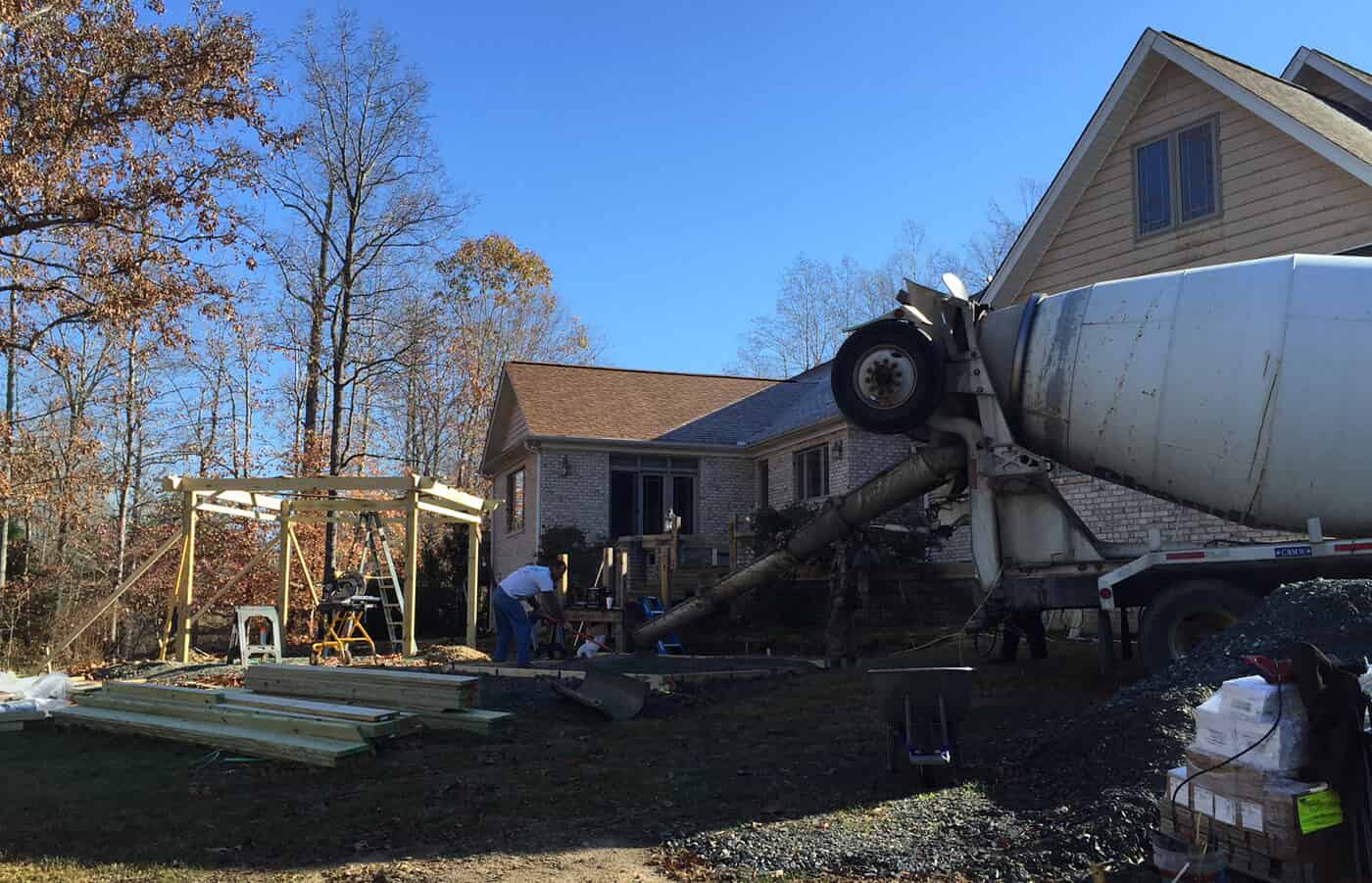 cement truck in front of house with gazebo under construction