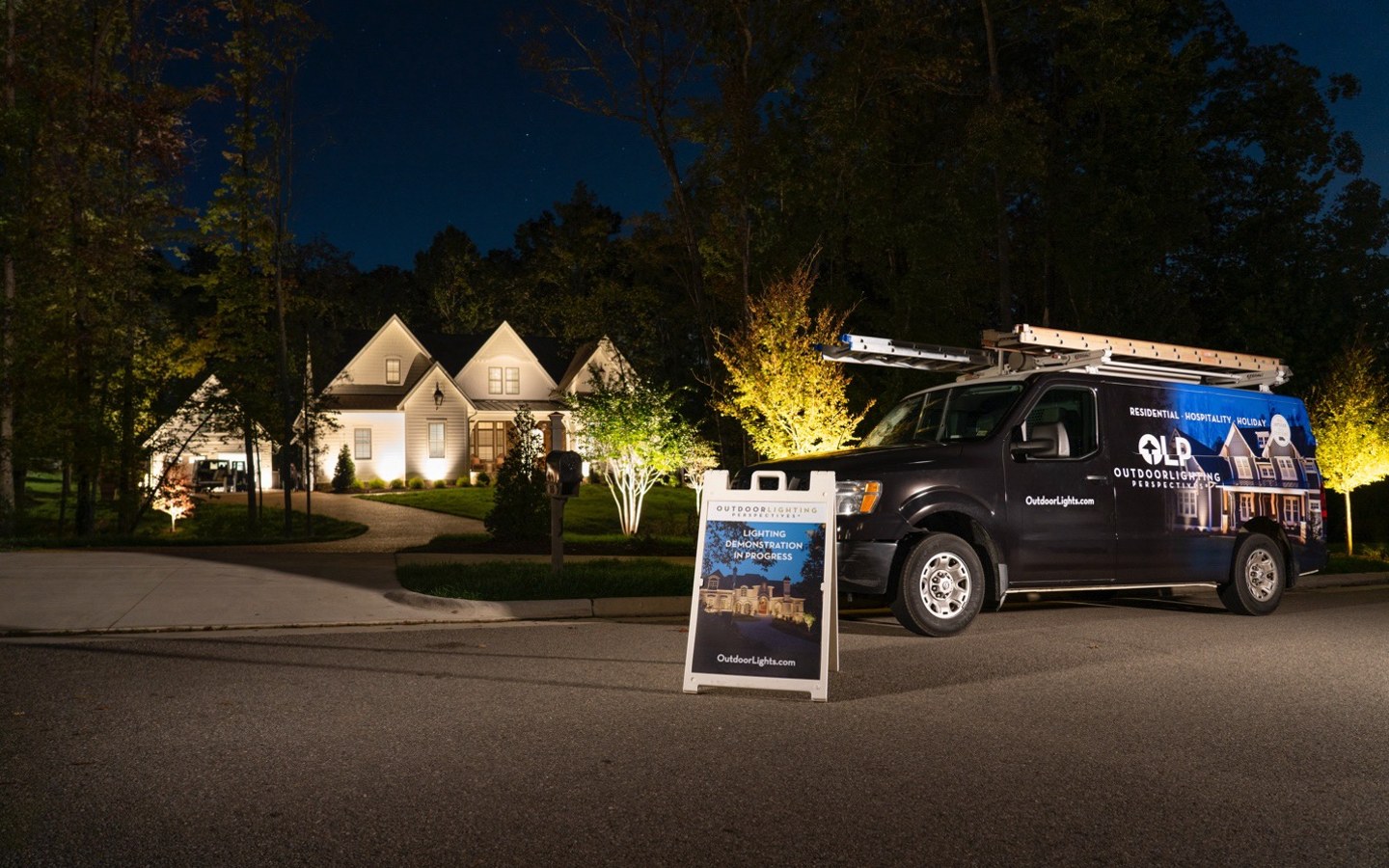 A black van parked in front of a house

Description automatically generated
