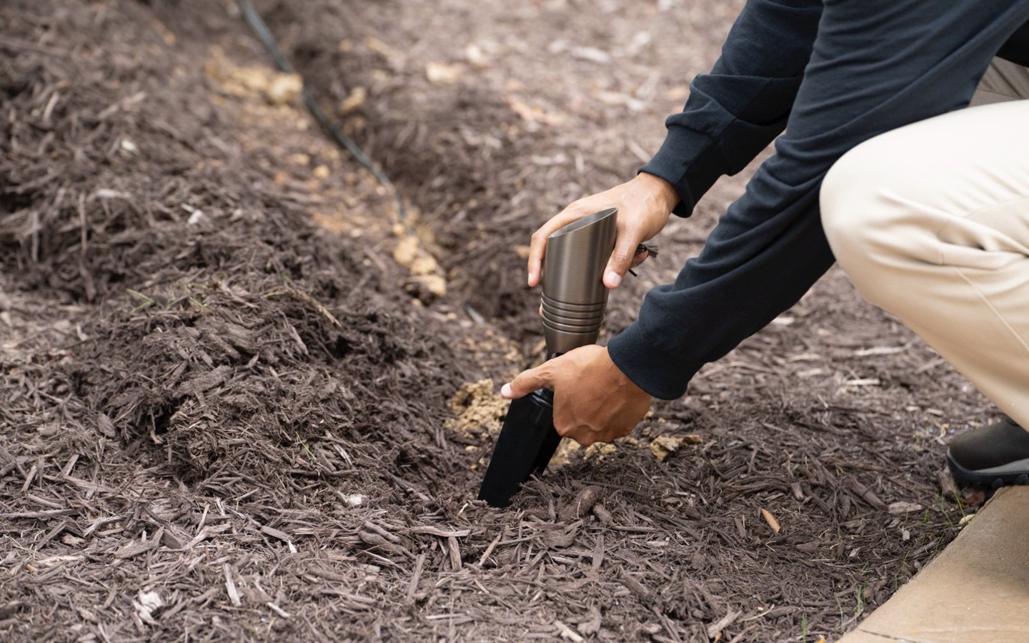 A person digging in the ground

Description automatically generated