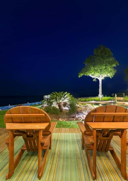 patio furniture and outdoor lighting overlooking the ocean