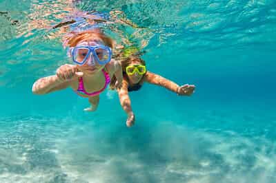 Two girls swimming underwater