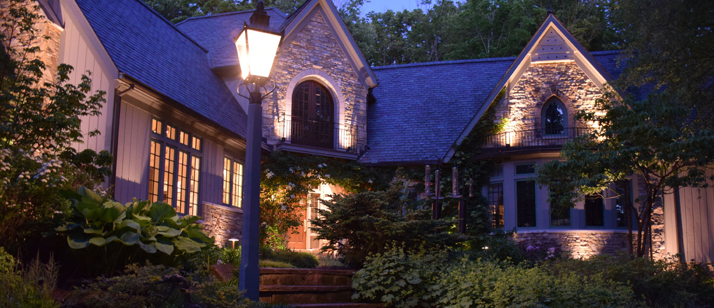 architectural lighting on the front of a stone house  