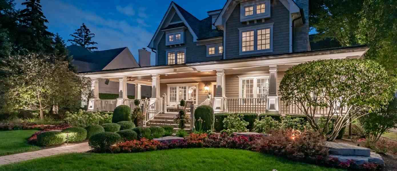 two story house illuminated by outdoor lighting