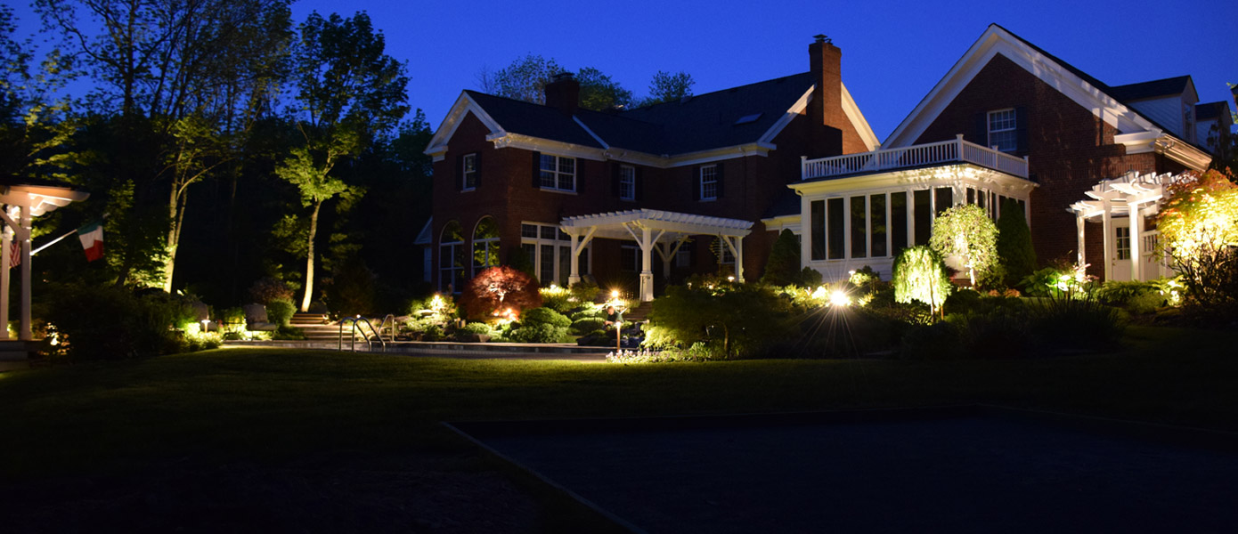 landscape and architectural lighting of a house and backyard 