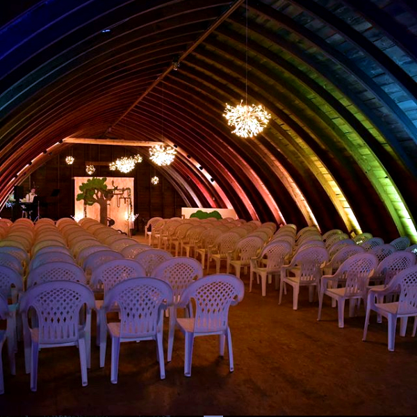 barn with rainbow wedding lighting 