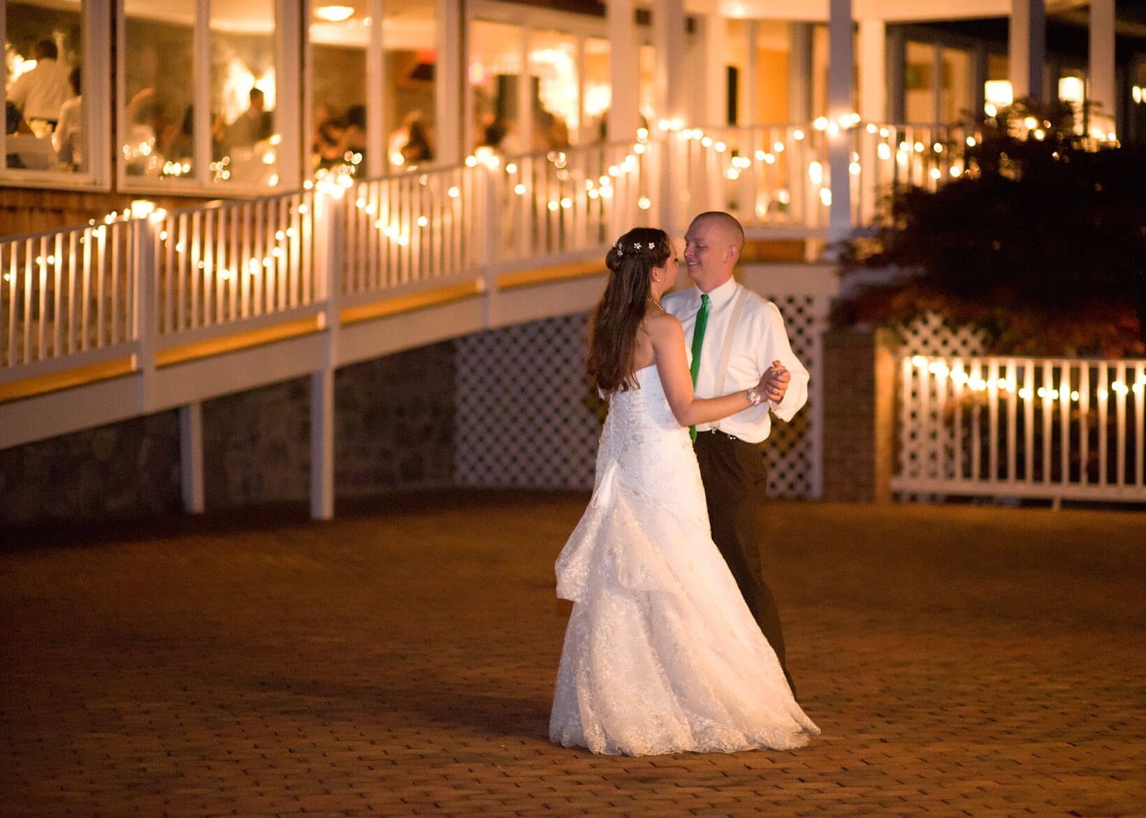 Couple dancing at well lit wedding