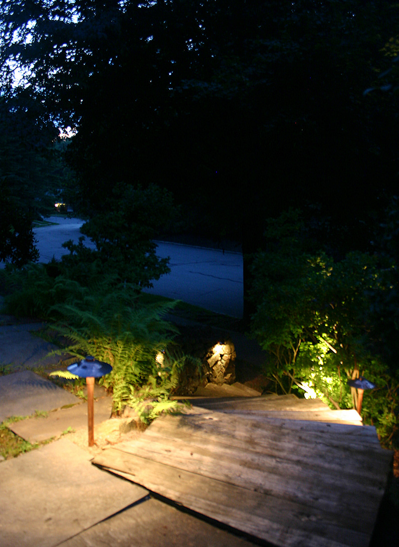 Wooden steps at a residence with pathway lighting