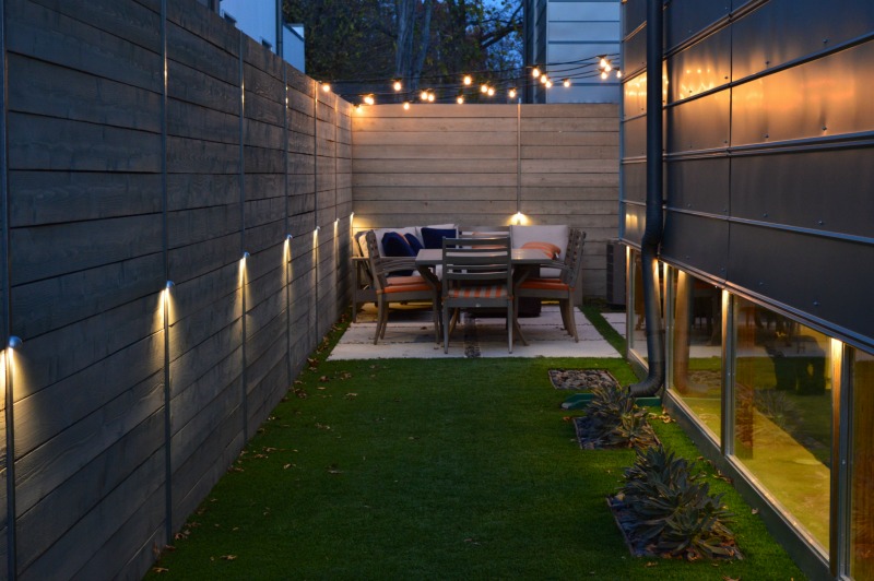 Outdoor area with a small patio and festive lights