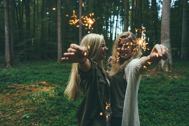 Two girls holding firework sparklers