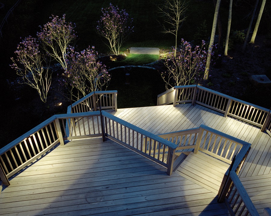 Large deck with railing, stairs and lighting