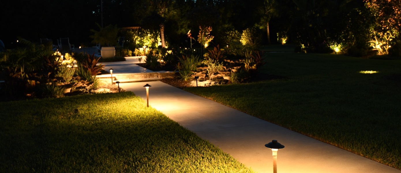 an outdoor walkway lined with white lighting