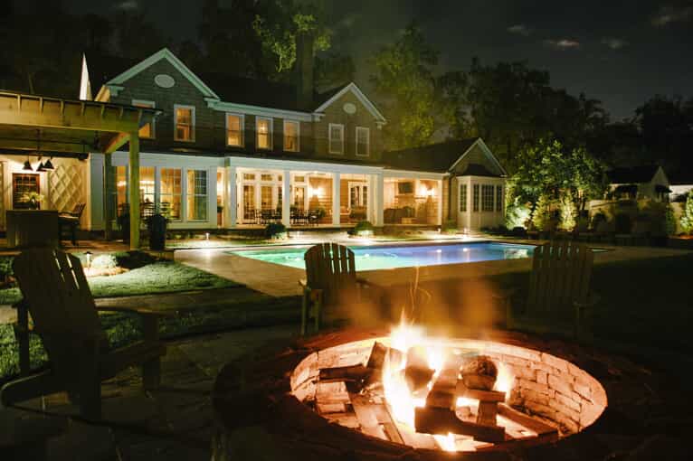 fire pit in backyard with pool