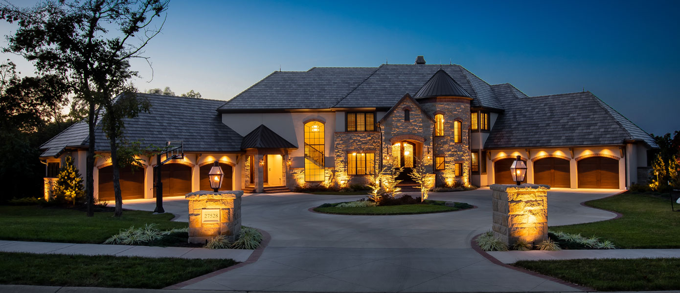 A large house with lights onDescription automatically generated