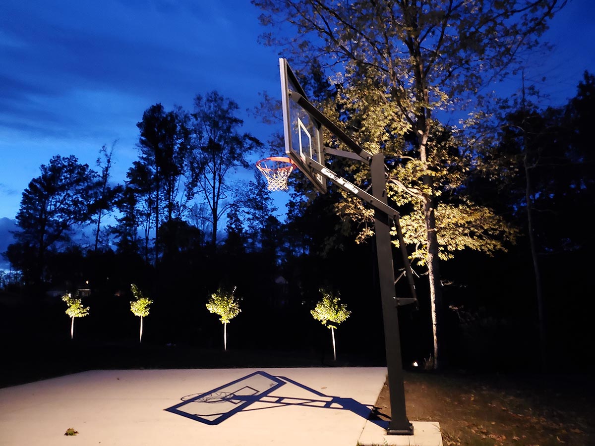 back yard lighting and basketball court illumination for a home 