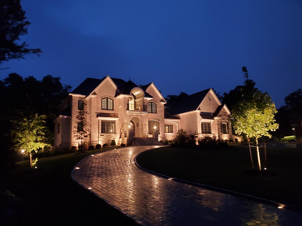 large home with outdoor lighting